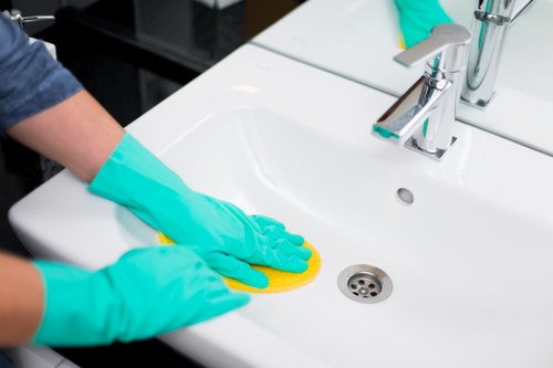 Finchley cleaning expert tidying a modern kitchen with care